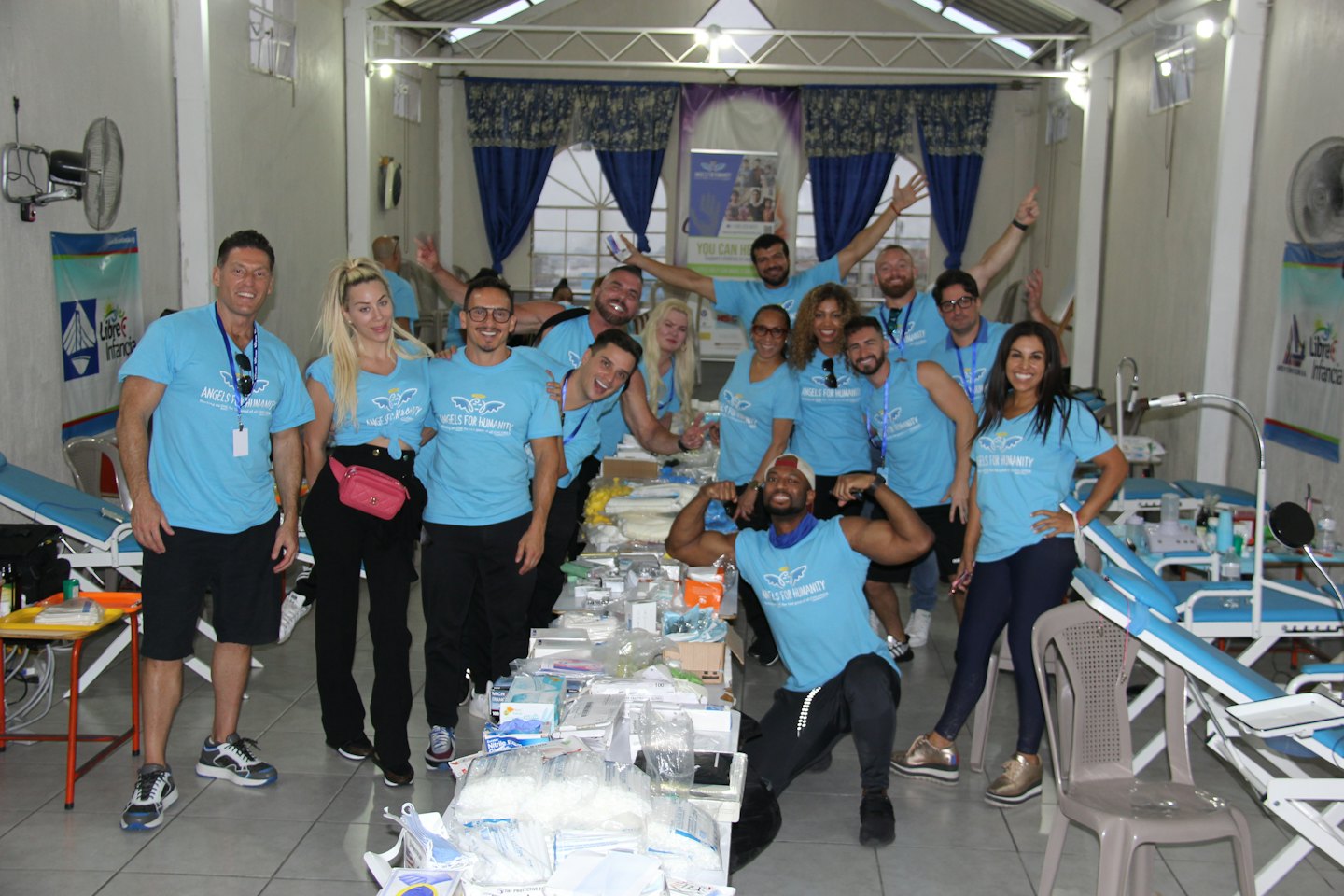Volunteer team in branded shirts at a mobile medical clinic.